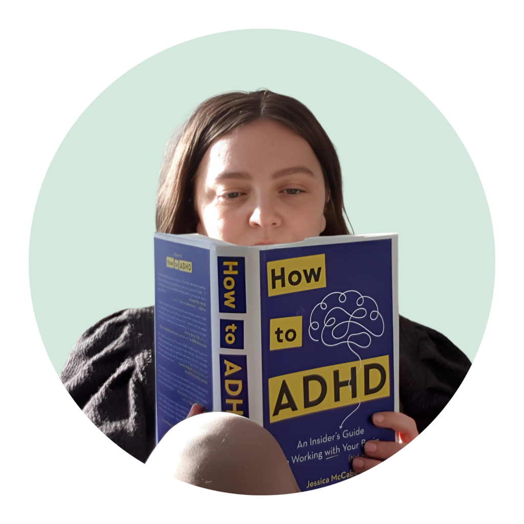 audhc coach is reading a book titled "how to adhd"